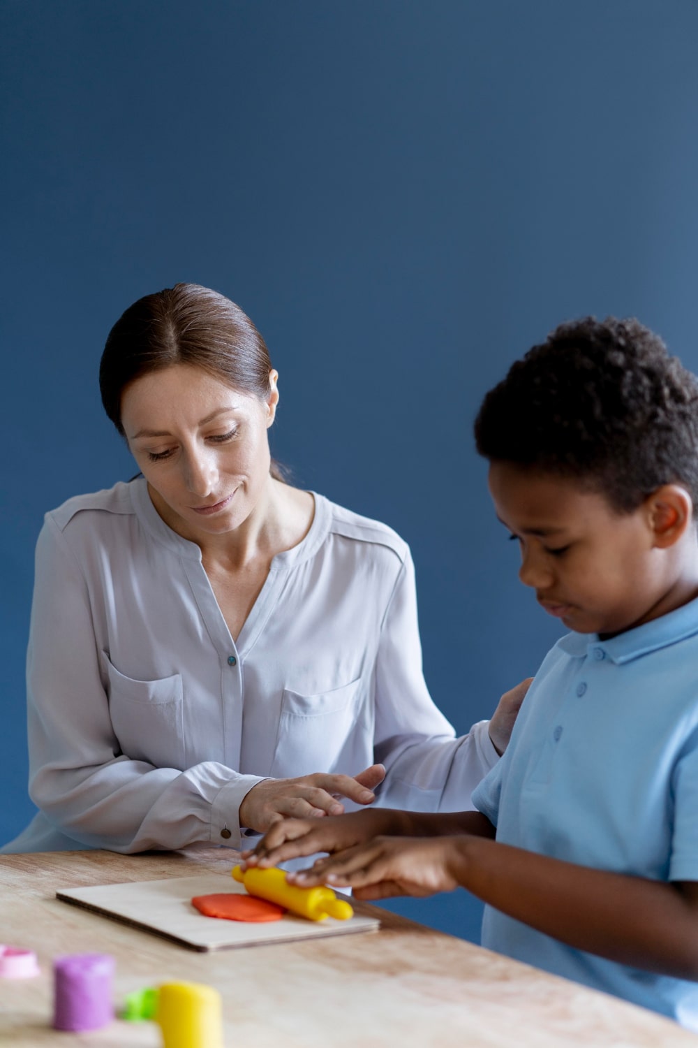 kid-doing-occupational-therapy-session-with-psychologist-min